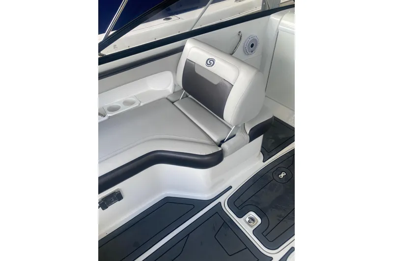 Slide: The Image of 2023 Hurricane SunDeck 235 OB boat interior with cushioned seating and cup holders. - 29