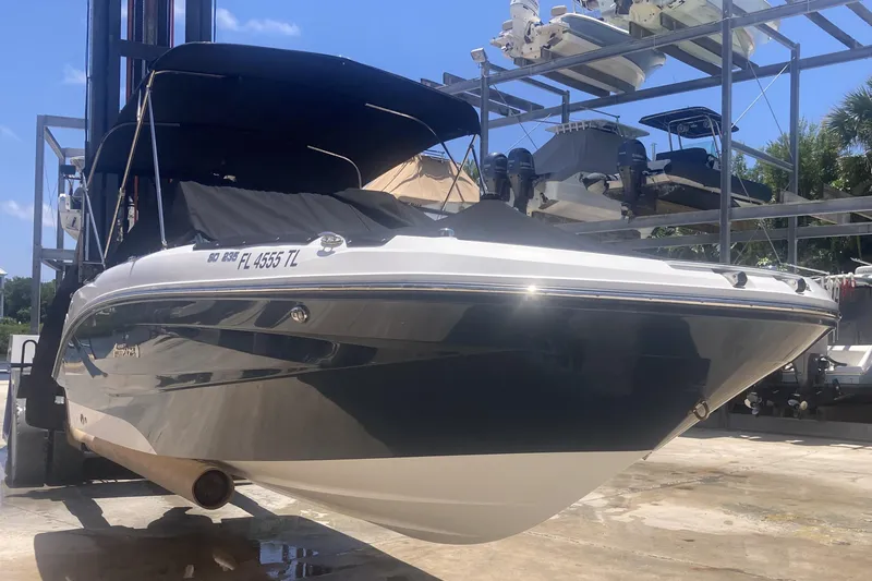 The Image of 2023 Hurricane SunDeck 235 OB boat on lift, covered and ready for storage. - 3