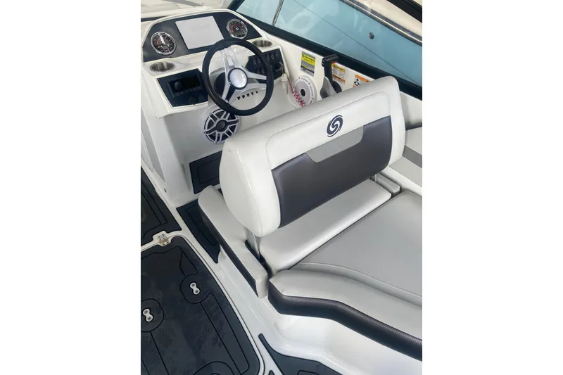 Slide: The Image of 2023 Hurricane SunDeck 235 OB boat interior with steering wheel and cushioned seating. - 30