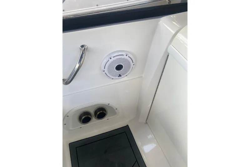 Slide: The Image of Interior view of 2023 Hurricane SunDeck 235 OB boat, featuring speaker and stainless steel handle. - 31