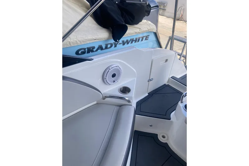 Slide: The Image of 2023 Hurricane SunDeck 235 OB boat interior with seating and speaker detail. - 33