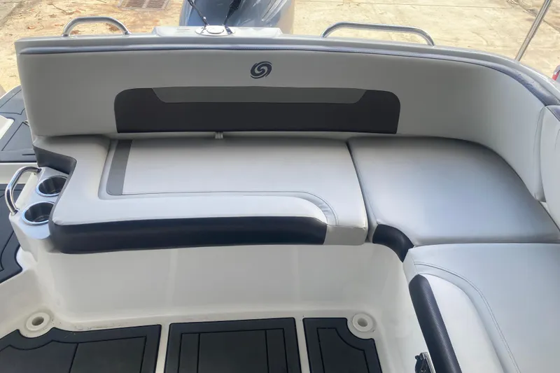 Slide: The Image of 2023 Hurricane SunDeck 235 OB boat seating area with cup holders and sleek design. - 35