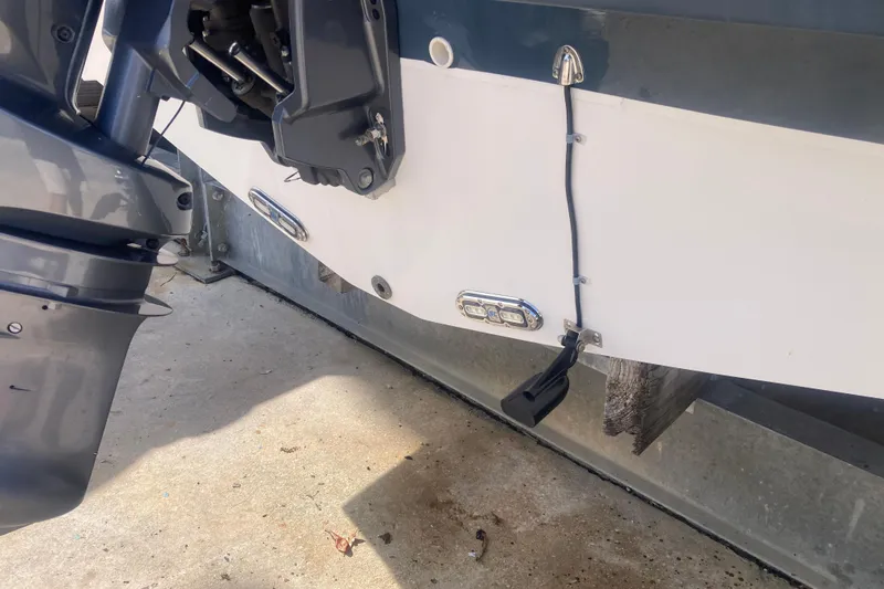 Slide: The Image of 2023 Hurricane SunDeck 235 OB boat's rear view with motor and wiring details. - 36