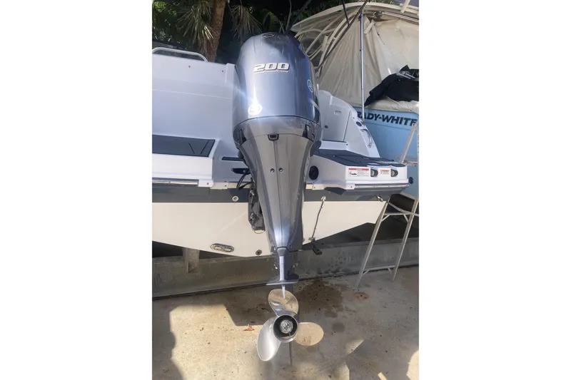 Slide: The Image of 2023 Hurricane SunDeck 235 OB boat with powerful outboard motor. - 37