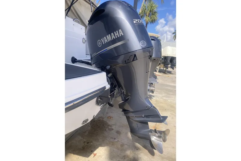 Slide: The Image of 2023 Hurricane SunDeck 235 OB with Yamaha 200 outboard motor, docked outdoors. - 38