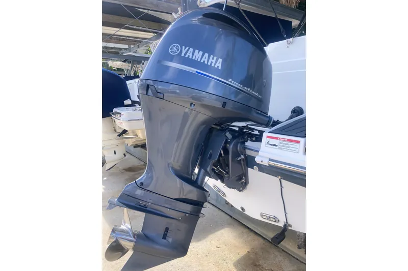 Slide: The Image of Yamaha outboard motor on 2023 Hurricane SunDeck 235 OB boat, docked outdoors. - 39