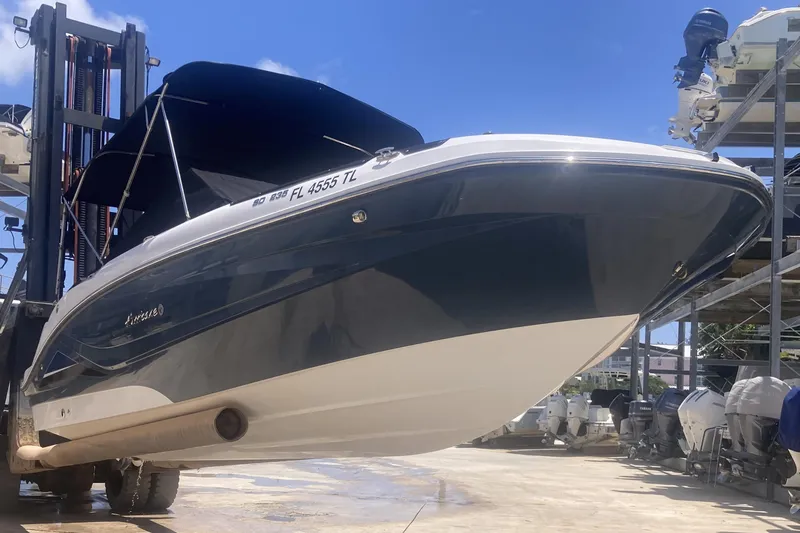 Slide: The Image of 2023 Hurricane SunDeck 235 OB boat on lift, showcasing sleek design and modern features. - 6