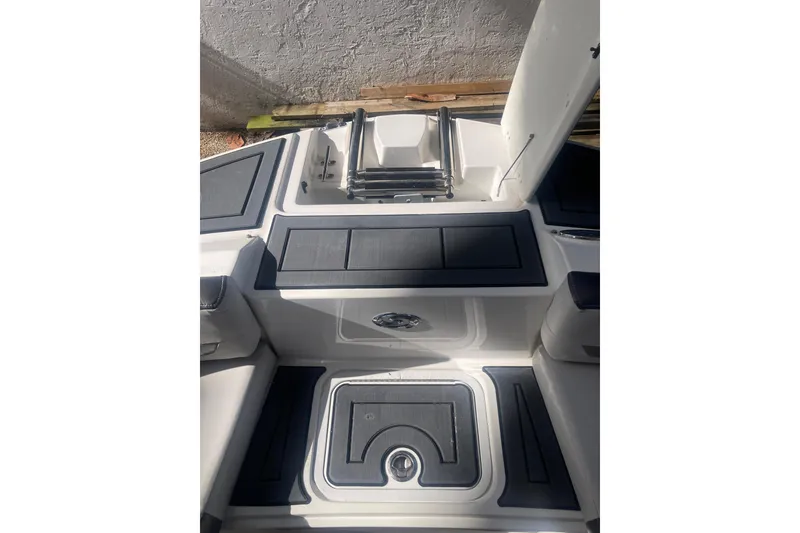Slide: The Image of 2023 Hurricane SunDeck 235 OB boat interior with sleek seating and storage compartments. - 7