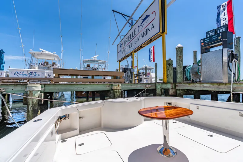 Slide: The Image of The image shows the cockpit of a 2004 Ocean Yachts 50 Convertible docked at a marina. - 23