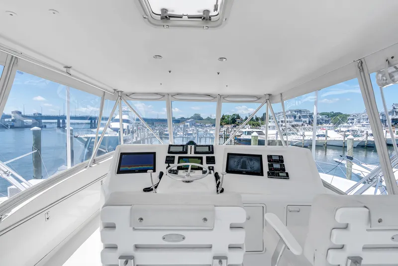 Slide: The Image of The cockpit of a 2004 Ocean Yachts 50 Convertible overlooking a marina. - 26