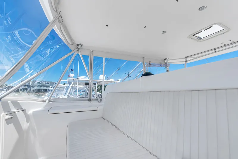 Slide: The Image of Interior view of a yacht with white upholstered seating and large windows showing a clear sky. - 31