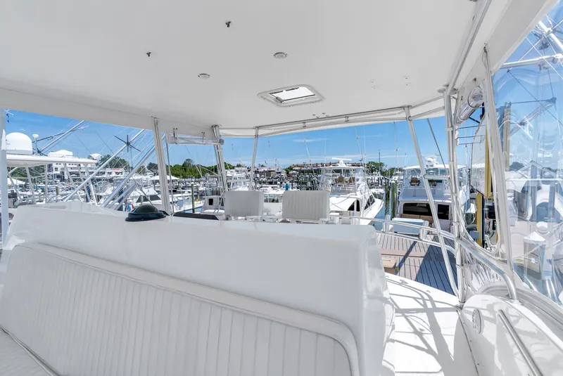 Slide: The Image of The image shows the cockpit of a 2004 Ocean Yachts 50 Convertible at a marina. - 32