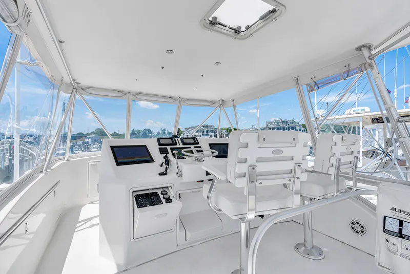 Slide: The Image of The image shows the helm of a 2004 Ocean Yachts 50 Convertible with modern electronics. - 36