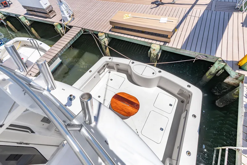 Slide: The Image of The image shows the stern of a boat with a spacious cockpit and a wooden table. - 39