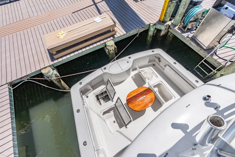 Slide: The Image of Top view of a boat at the dock with open cockpit and wooden table. - 40