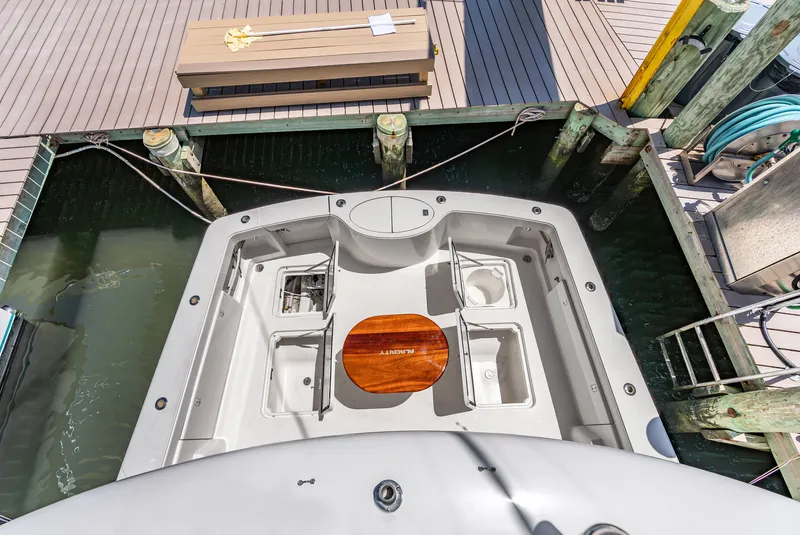 Slide: The Image of The image shows the cockpit of a 2004 Ocean Yachts 50 Convertible. It is docked. - 42