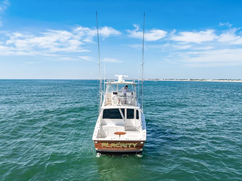 Slide: The Image of A 2004 Ocean Yachts 50 Convertible cruising on open water under a clear sky. - 6