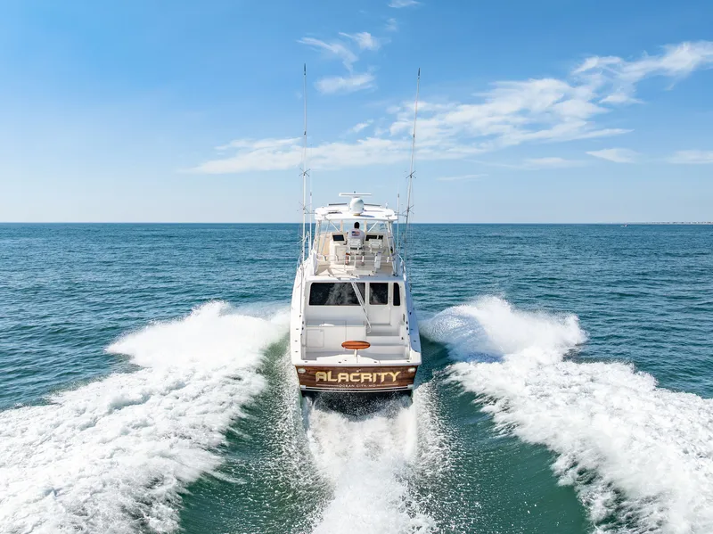 Slide: The Image of A 2004 Ocean Yachts 50 Convertible speeds across the sea, leaving a white wake behind. - 8