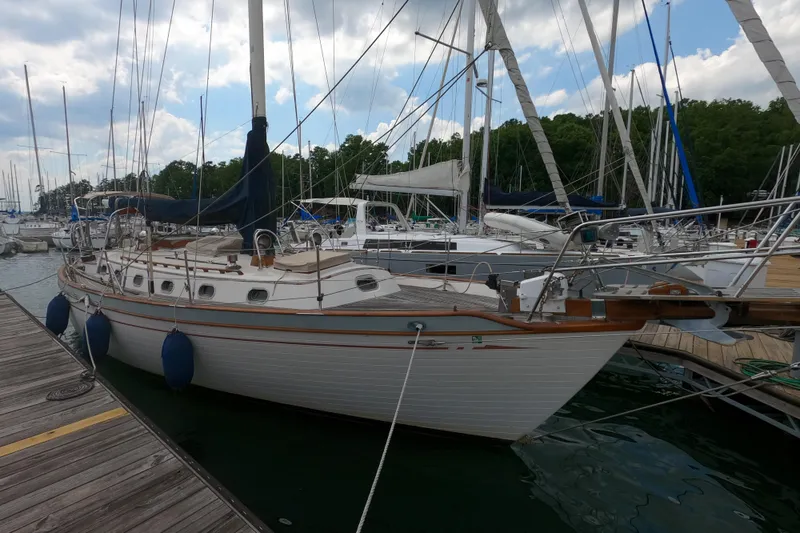 The Image of 1986 Ta Shing Baba 40 sailboat docked at marina, surrounded by other boats. - 0