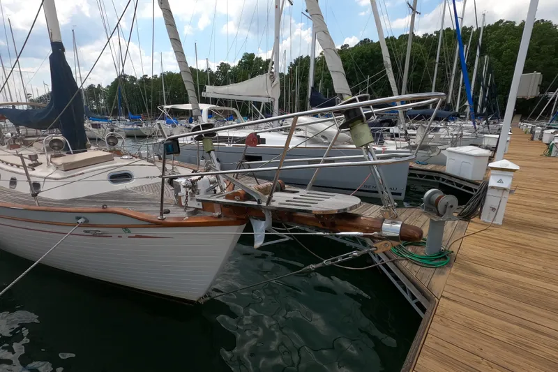 Slide: The Image of Sailboat docked at marina, Ta Shing Baba 40, 1986 model, with wooden deck details. - 1