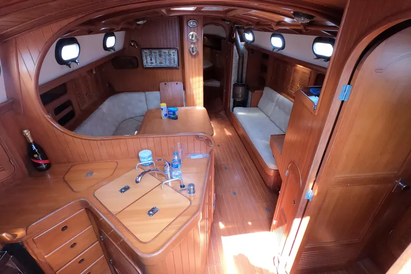 Slide: The Image of Interior of 1986 Ta Shing Baba 40 sailboat with wooden finishes and cozy seating area. - 11