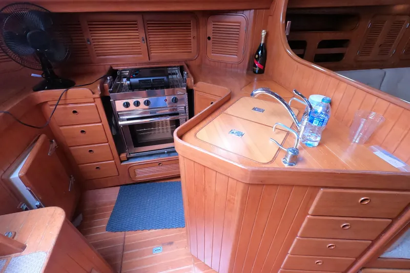 Slide: The Image of 1986 Ta Shing Baba 40 yacht kitchen with wooden cabinetry and modern appliances. - 14