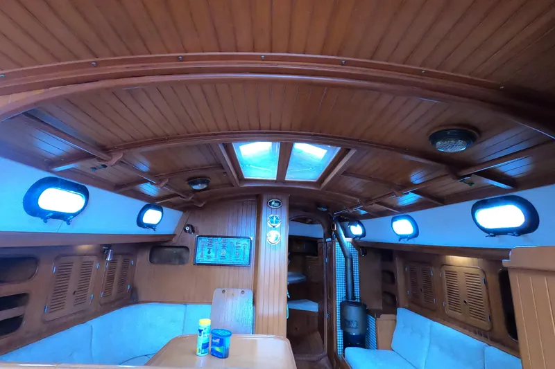 Slide: The Image of Interior of 1986 Ta Shing Baba 40 sailboat with wooden paneling and cozy seating area. - 16