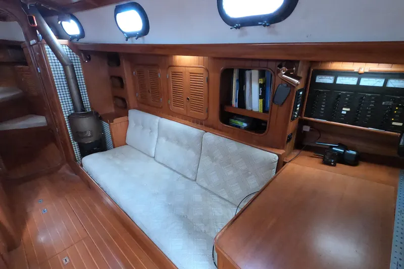 Slide: The Image of Interior of 1986 Ta Shing Baba 40 sailboat with wood paneling and cozy seating area. - 18
