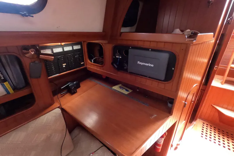 Slide: The Image of 1986 Ta Shing Baba 40 yacht interior with navigation equipment and wooden cabinetry. - 19