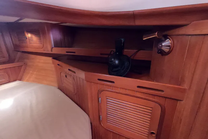 Slide: The Image of 1986 Ta Shing Baba 40 yacht interior with wooden cabinetry and fan. - 23