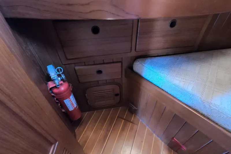 Slide: The Image of 1986 Ta Shing Baba 40 yacht interior with wooden cabinetry and fire extinguisher. - 26