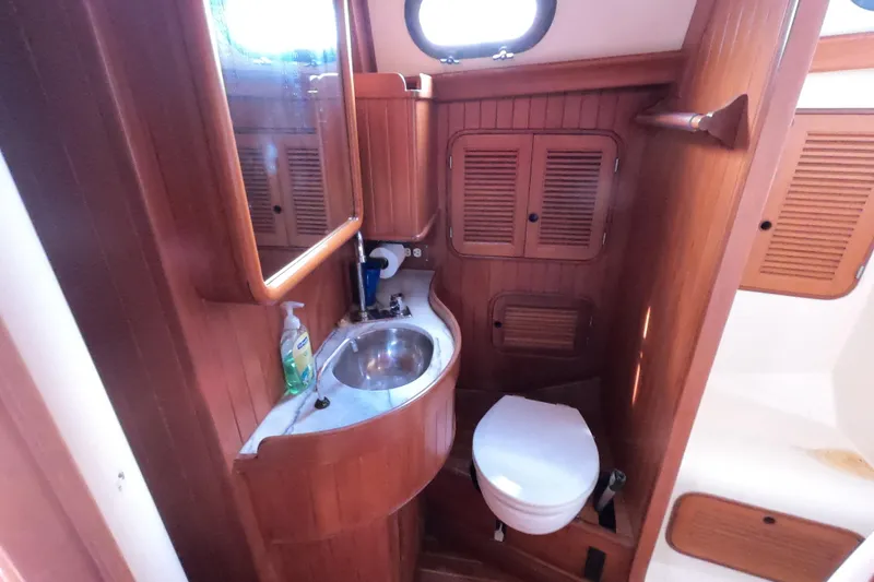 Slide: The Image of 1986 Ta Shing Baba 40 yacht bathroom with wooden cabinetry and compact design. - 27