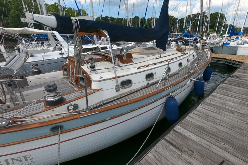 Slide: The Image of 1986 Ta Shing Baba 40 sailboat docked at marina, featuring classic design and wooden accents. - 3