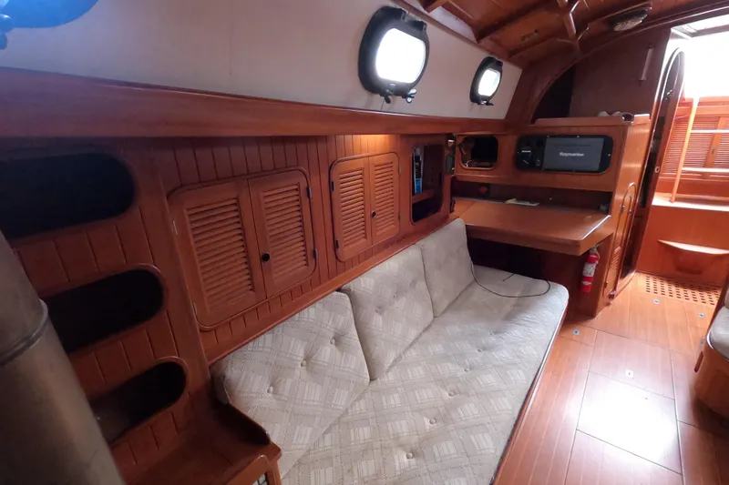 Slide: The Image of Interior of 1986 Ta Shing Baba 40 sailboat with wooden cabinetry and cozy seating area. - 30