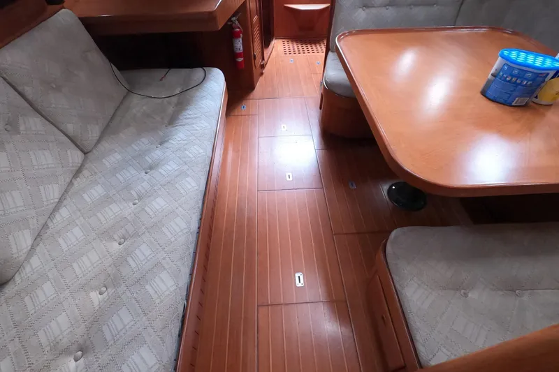 Slide: The Image of Interior of 1986 Ta Shing Baba 40 sailboat with wooden flooring and cushioned seating. - 32