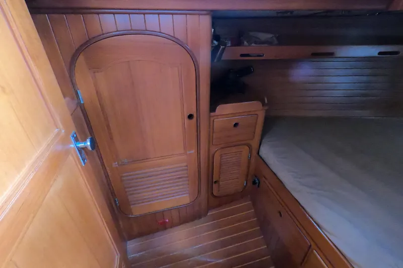 Slide: The Image of Interior of 1986 Ta Shing Baba 40 sailboat with wooden cabinetry and cozy sleeping area. - 34