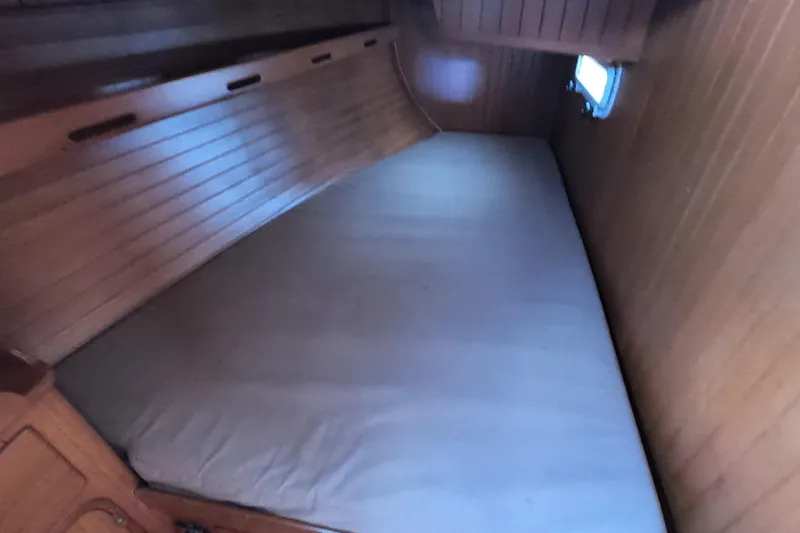 Slide: The Image of Cozy cabin interior of 1986 Ta Shing Baba 40 sailboat with wooden paneling and mattress. - 35