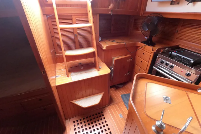Slide: The Image of Interior of 1986 Ta Shing Baba 40 sailboat with wooden cabinetry and compact kitchen. - 36