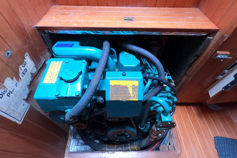 Slide: The Image of Engine compartment of a 1986 Ta Shing Baba 40 sailboat, showcasing mechanical components. - 37