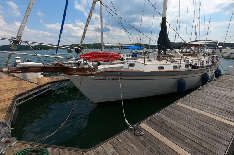 Slide: The Image of 1986 Ta Shing Baba 40 sailboat docked at marina under partly cloudy sky. - 4