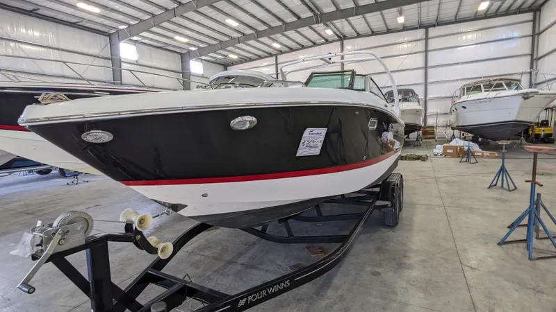 Slide: The Image of 2022 Four Winns 260H boat in warehouse on trailer. - 17