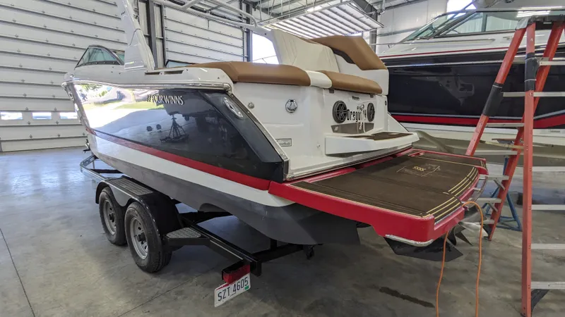 Slide: The Image of 2022 Four Winns 260H boat in warehouse on trailer. - 18