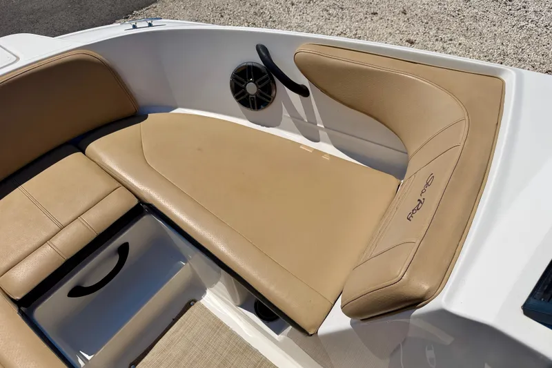 Slide: The Image of 2022 Sea Ray SPX 210 Outboard boat interior with tan seating and storage compartment. - 10