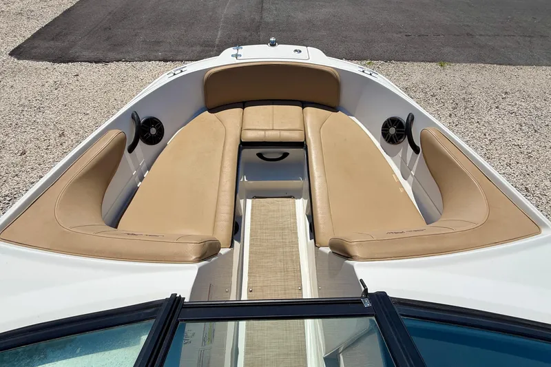 Slide: The Image of 2022 Sea Ray SPX 210 Outboard boat with tan seating and speakers in the bow area. - 11