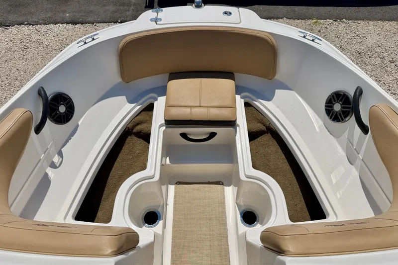 Slide: The Image of 2022 Sea Ray SPX 210 Outboard boat interior with tan seating and speakers. - 12