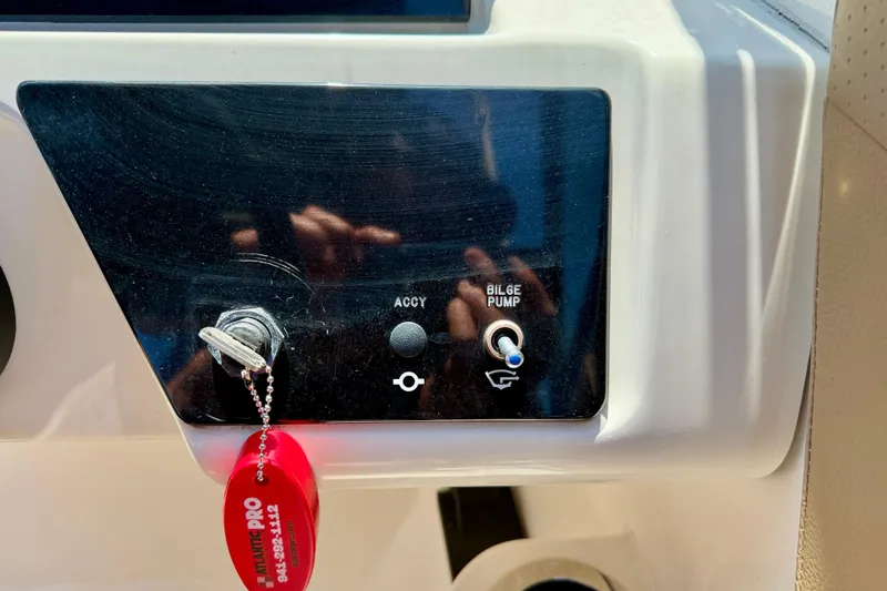 Slide: The Image of Control panel of 2022 Sea Ray SPX 210 Outboard with bilge pump switch. - 19