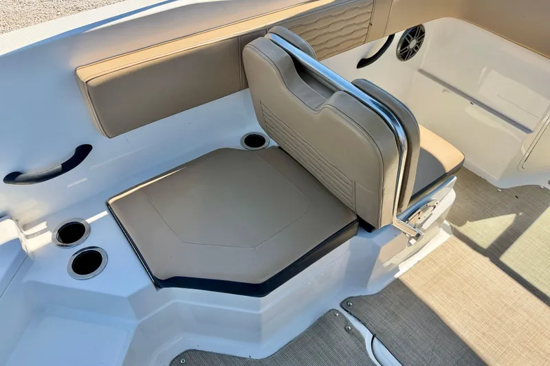 Slide: The Image of 2022 Sea Ray SPX 210 Outboard boat interior with beige seating and cup holders. - 23