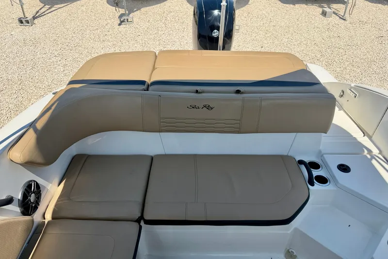 Slide: The Image of 2022 Sea Ray SPX 210 Outboard boat interior with tan seating and cup holders. - 24
