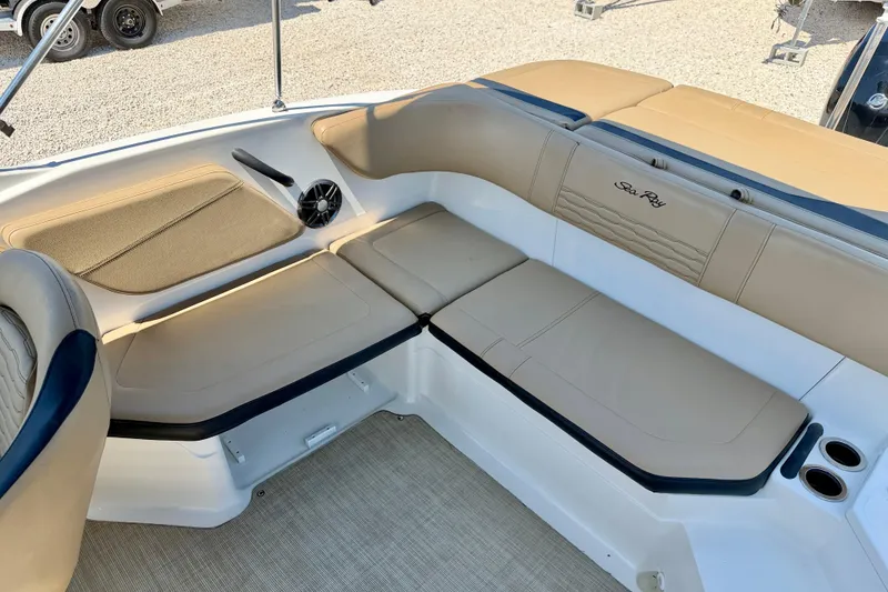 Slide: The Image of 2022 Sea Ray SPX 210 Outboard boat interior with beige seating and speaker. - 25