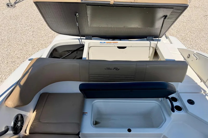 Slide: The Image of 2022 Sea Ray SPX 210 Outboard boat interior with open storage compartment and seating area. - 26